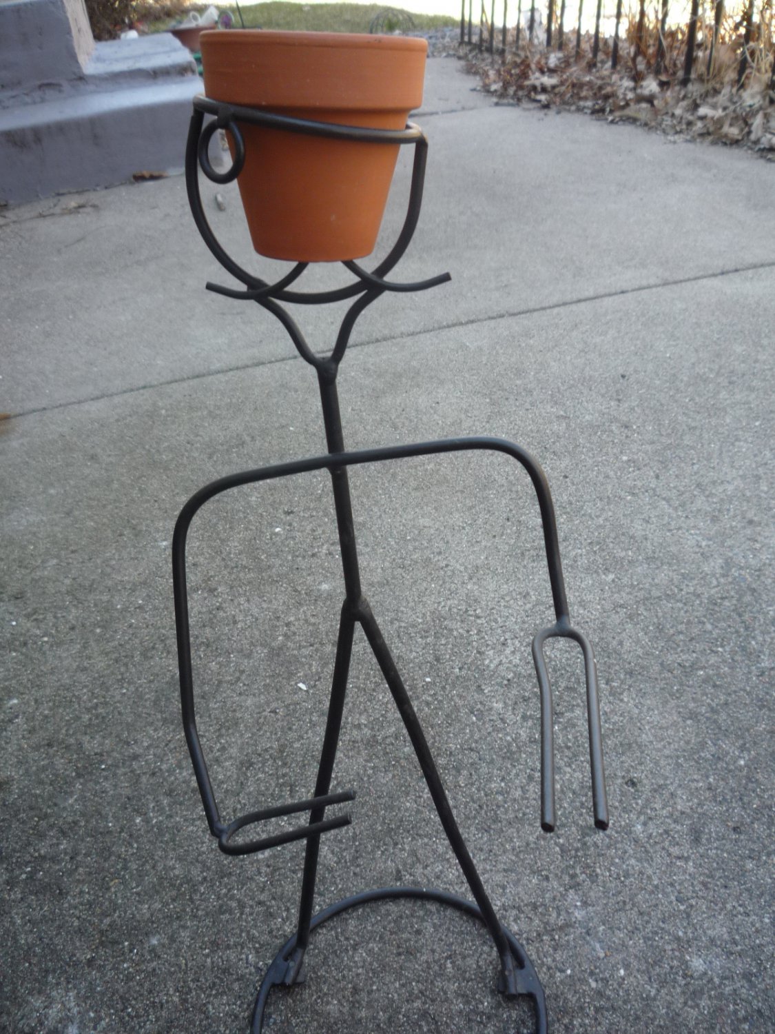 Metal plant/pot holder guy