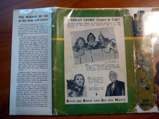 1939 MGM Wizard of Oz in original dust jacket with 8 color plates. Endpapers have stills from movie