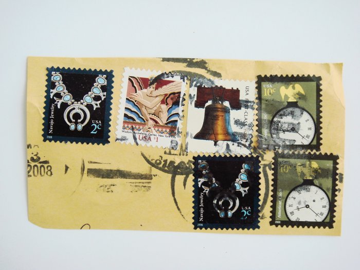 Partial Envelope with six United States Postage Stamps and Ink Postmark on it