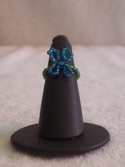 Butterfly ring, blue on dark green