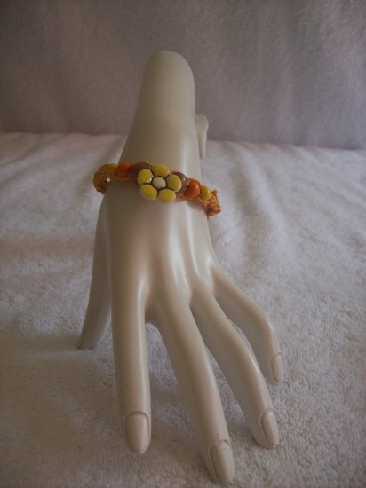 Yellow flower with wood beads on light orange square