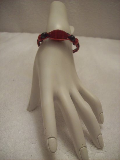 Red stone with wood beads on black and red square