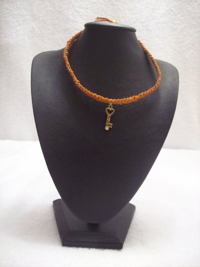 Gold heart key on orange square