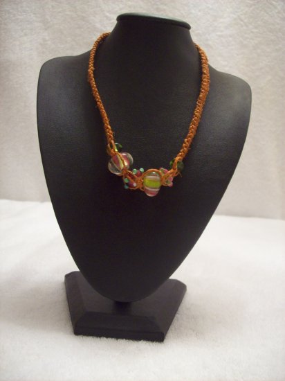 Abstract glass beads on orange square