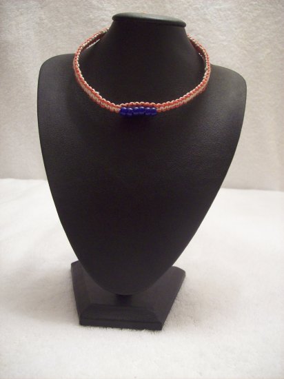 Blue beads (6, strung on) on red and white square