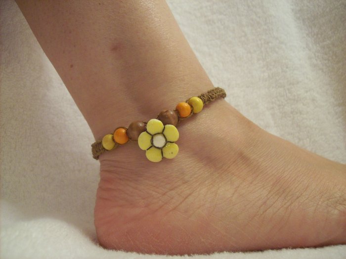 Yellow flower with wood beads on brown square