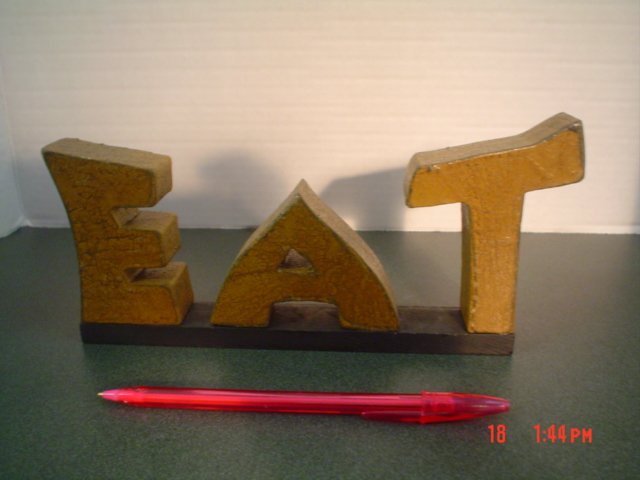 PRIMITIVE "EAT" WOOD WORD SIGN.