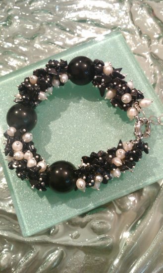 Multi gemstones and freshwater cultured white pearls in sterling sliver bracelet. 9’’