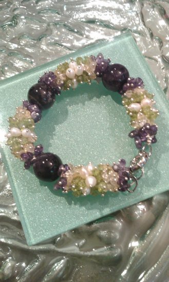Multi gemstones and freshwater cultured white pearls in sterling sliver bracelet. 9’’