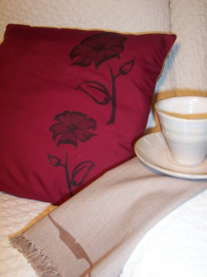 pair burgundy cushions with native design by Gina