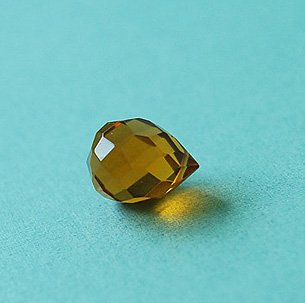 Dark yellow faceted glass briolette
