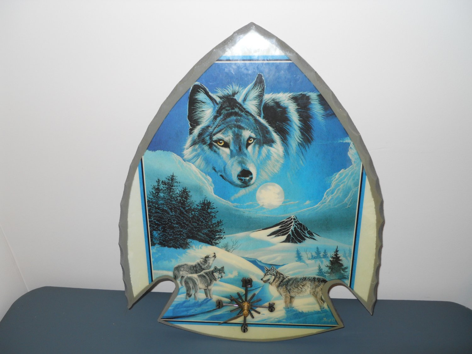 arrowhead shaped handmade wall clock - features wolves
