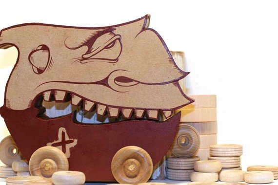 Wooden little monster toy on wheels made from found wood