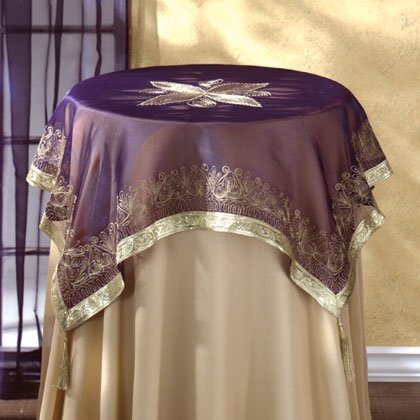 Purple Fabric Tablecloth With Gold Trim and Tassles.
