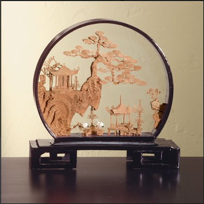 Cork sculpture with round black lacquer frame