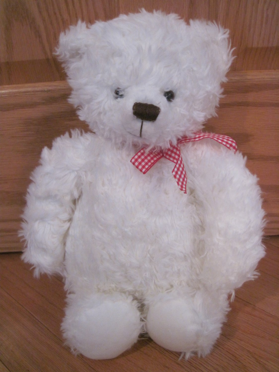 big white teddy bear with red bow