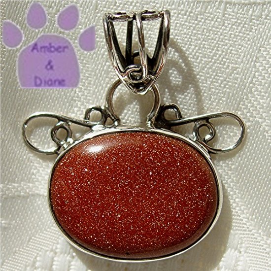 Goldstone Oval Sterling Silver Pendant in a filigree frame