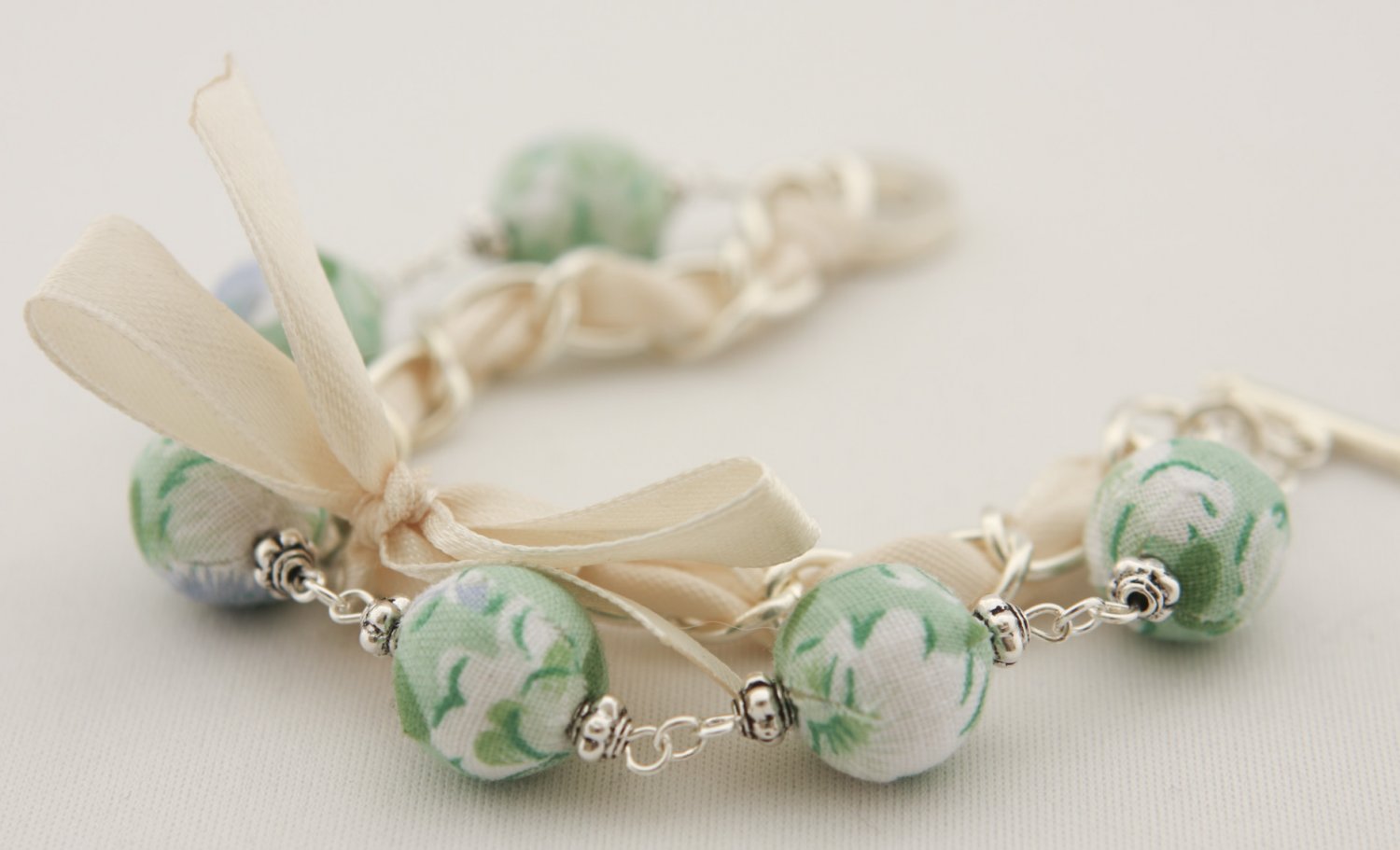 Light green floral cotton beads and beige satin ribbon bracelet