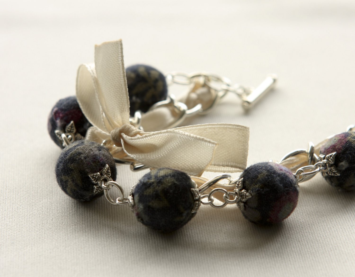 Black floral cotton beads and beige satin ribbon bracelet
