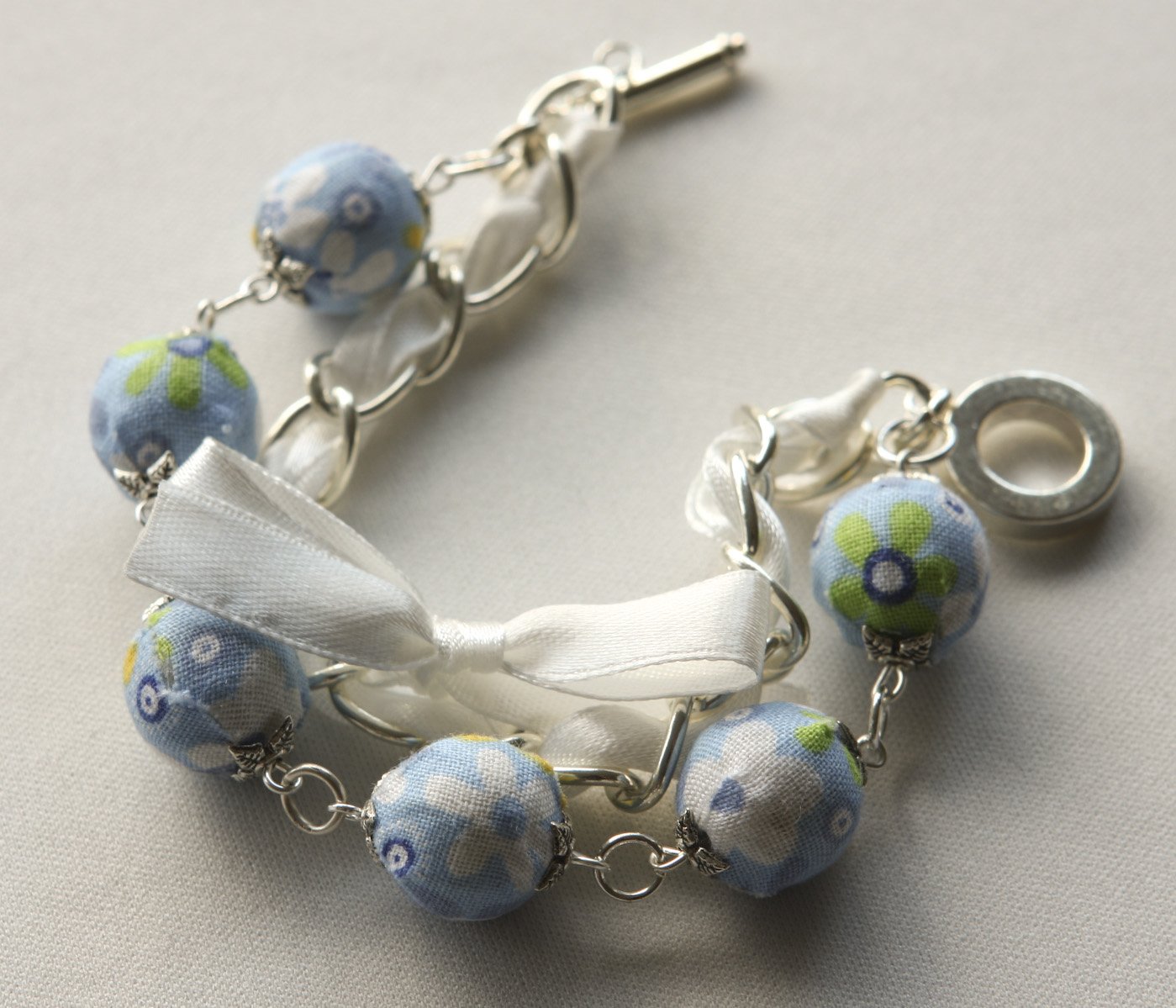 Blue cotton beads and white satin ribbon bracelet