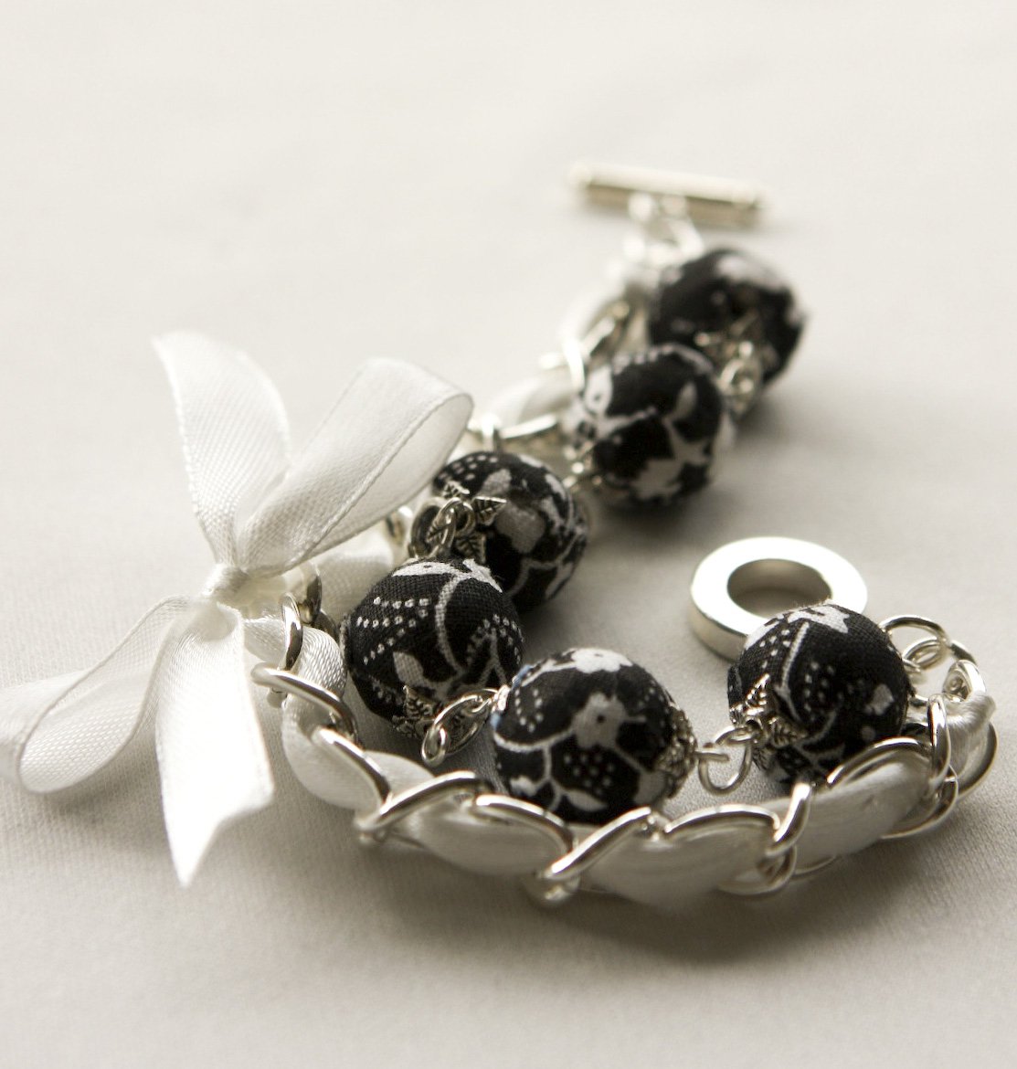 Black fabric beads and white satin ribbon bracelet