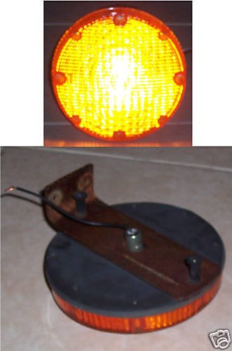 7" round Amber 12 Volt light with mounting bracket