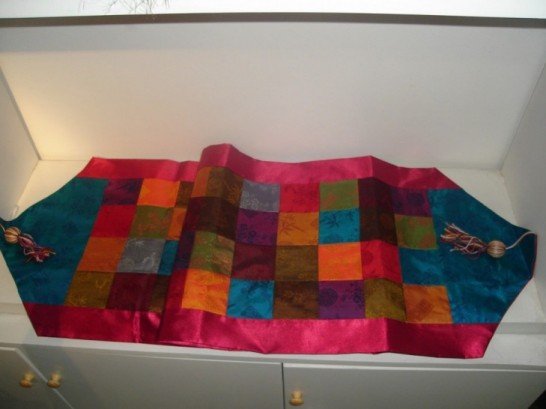 Patchwork table runner with V tassel