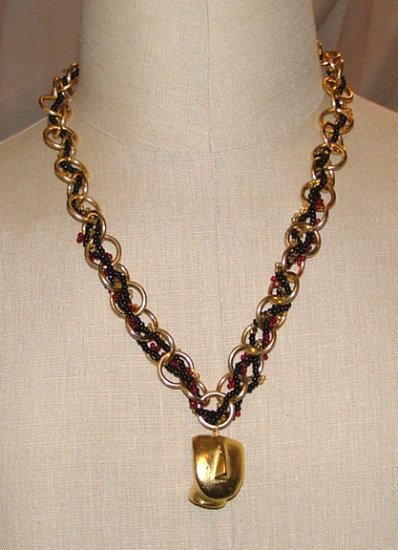 Chain and beaded necklace with face pendant