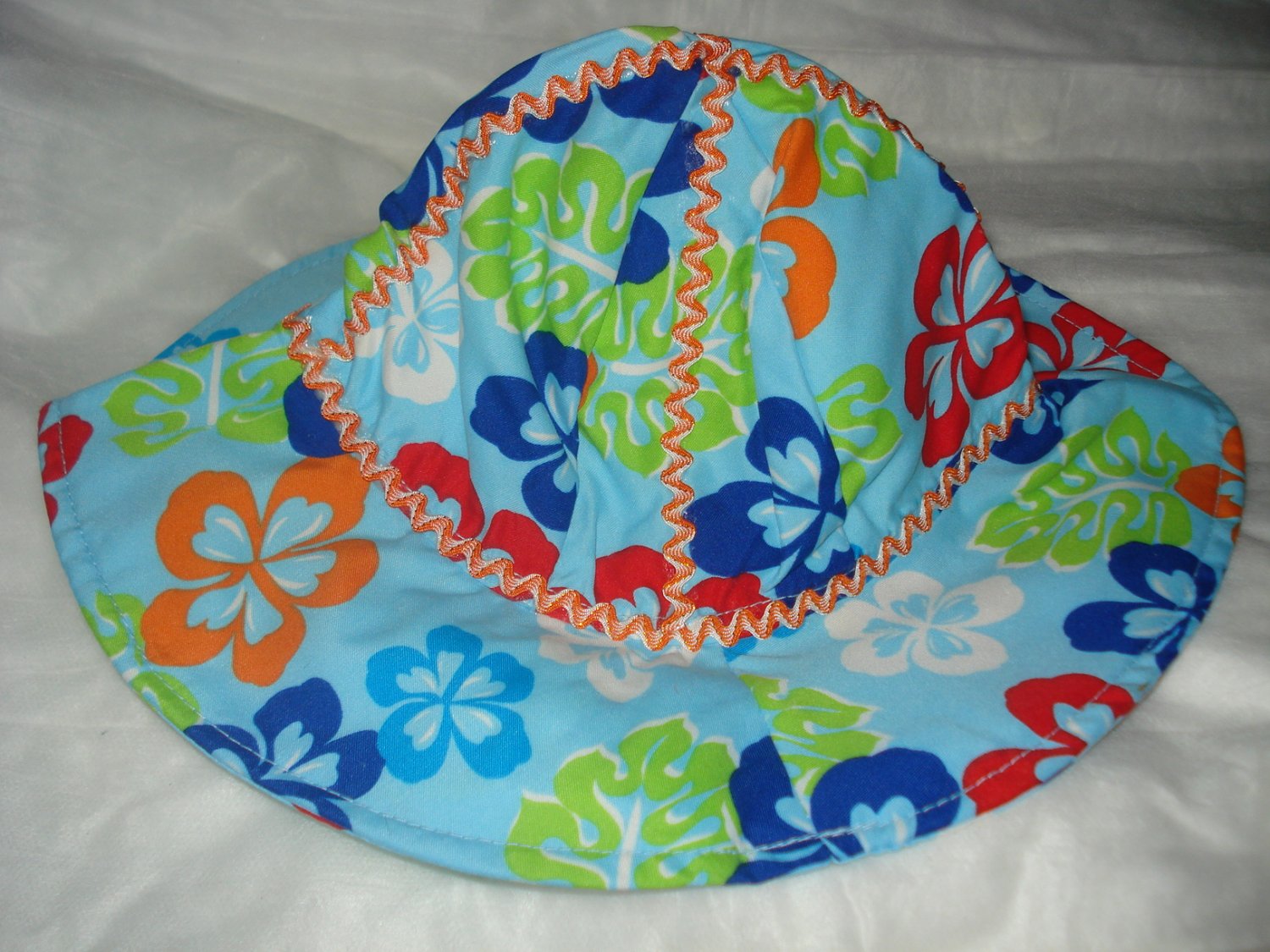 Baby / toddler hat in blue with multi-colored flowers - ekho1c