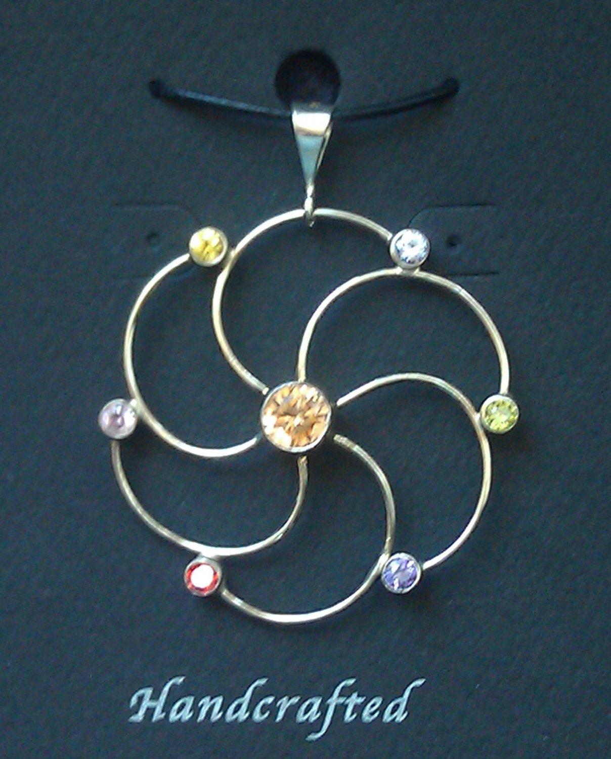 Sterling Silver Circle Pendant Accented with Cubic Zirconia Gems.