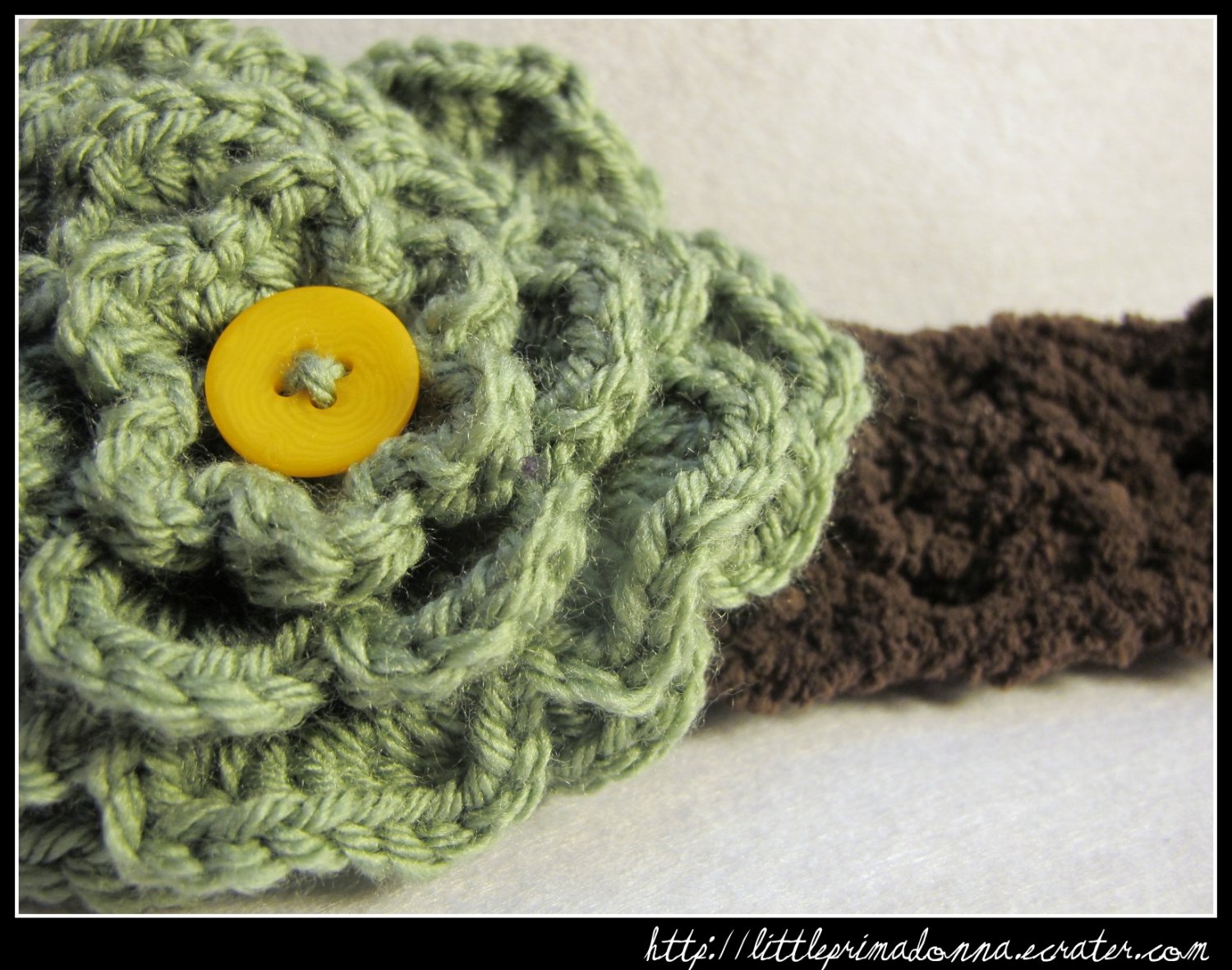 Crocheted headband with large green flower