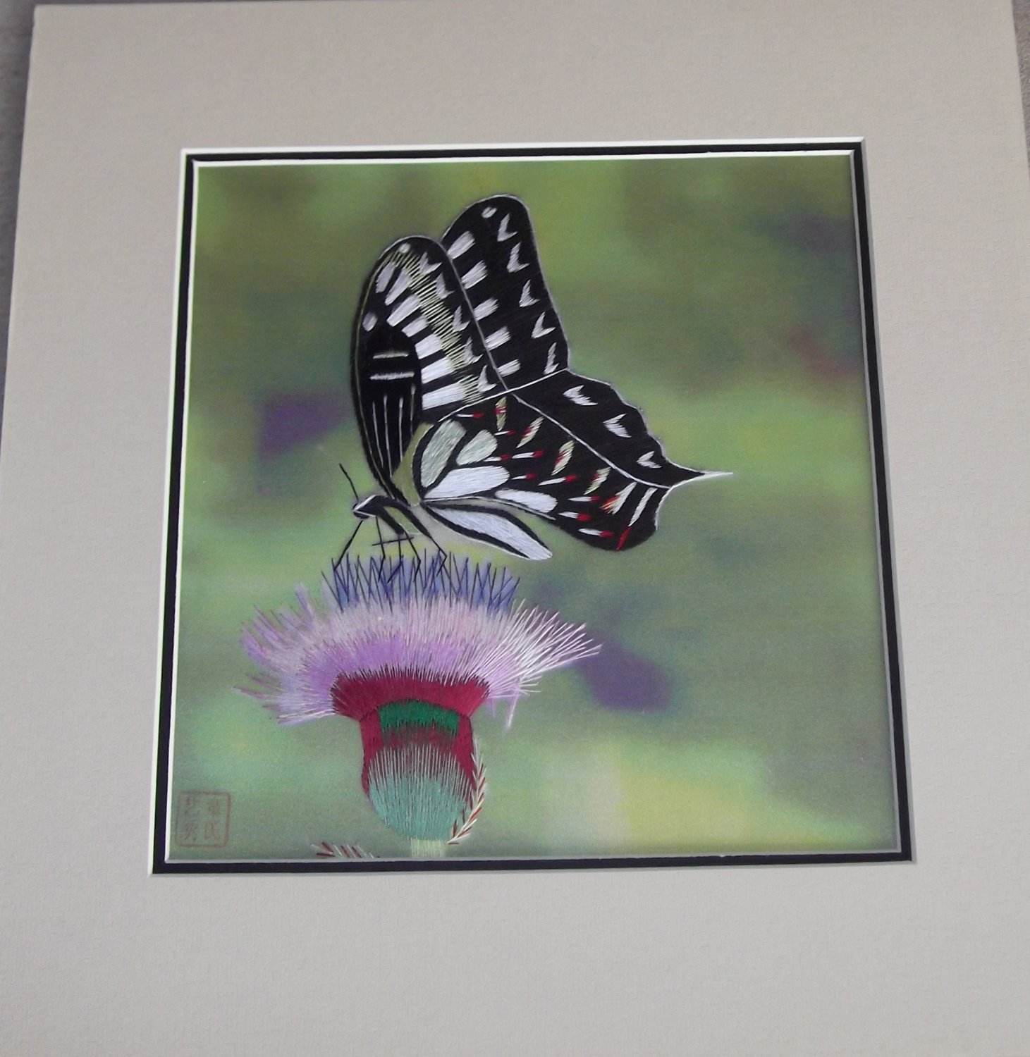 Black and white butterfly on a pink flower