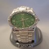 Men watch green face