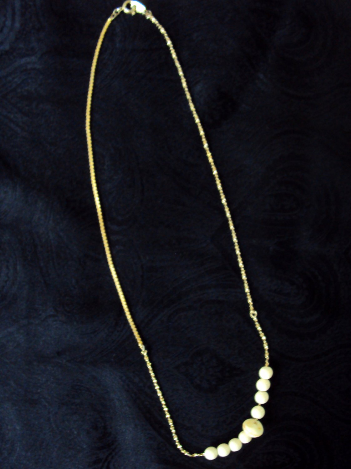 Asymmetrical necklace with cream colored beads, 18 1/2 inches