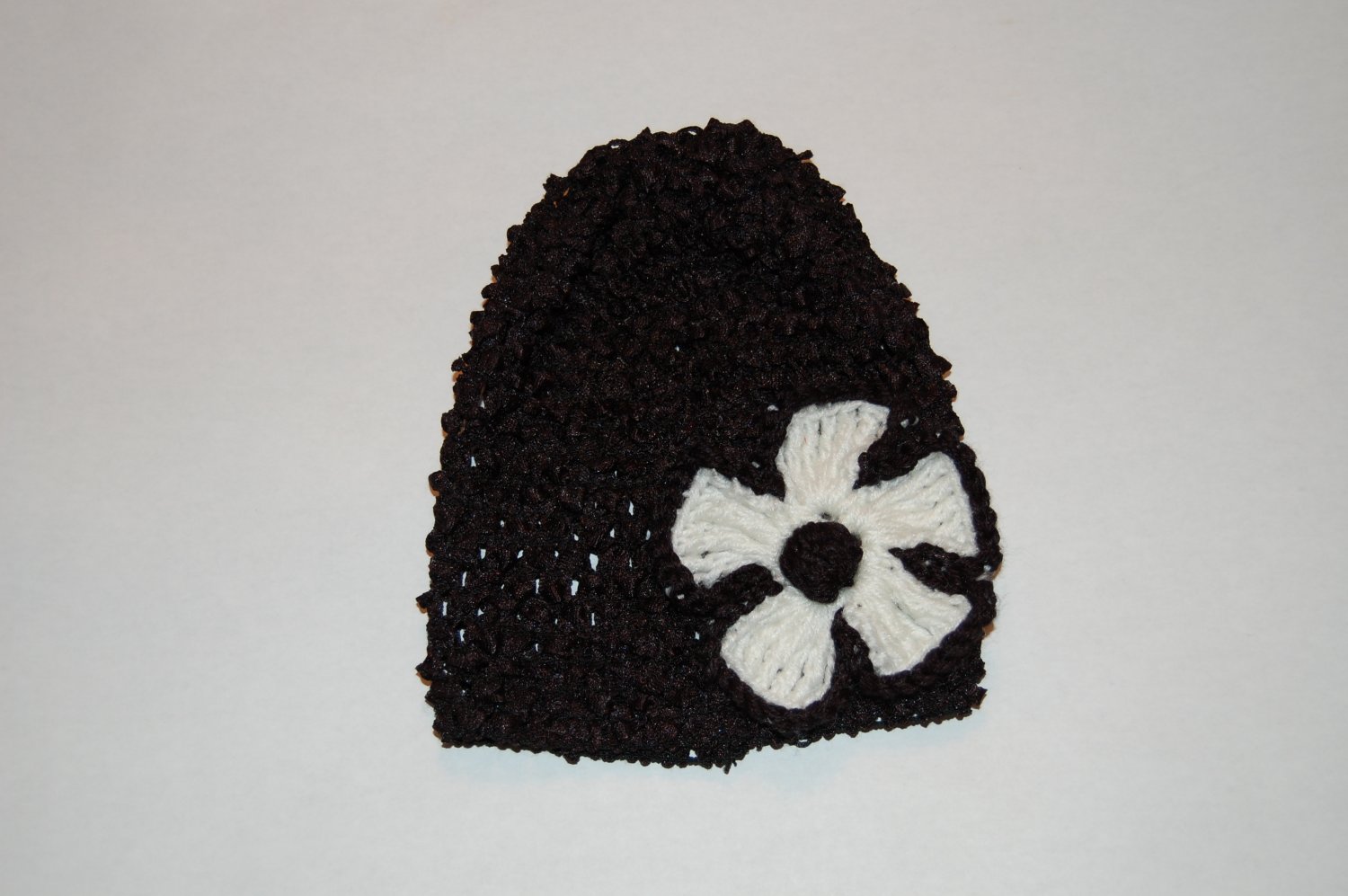 Crocheted Black Hat with White Crocheted Flower