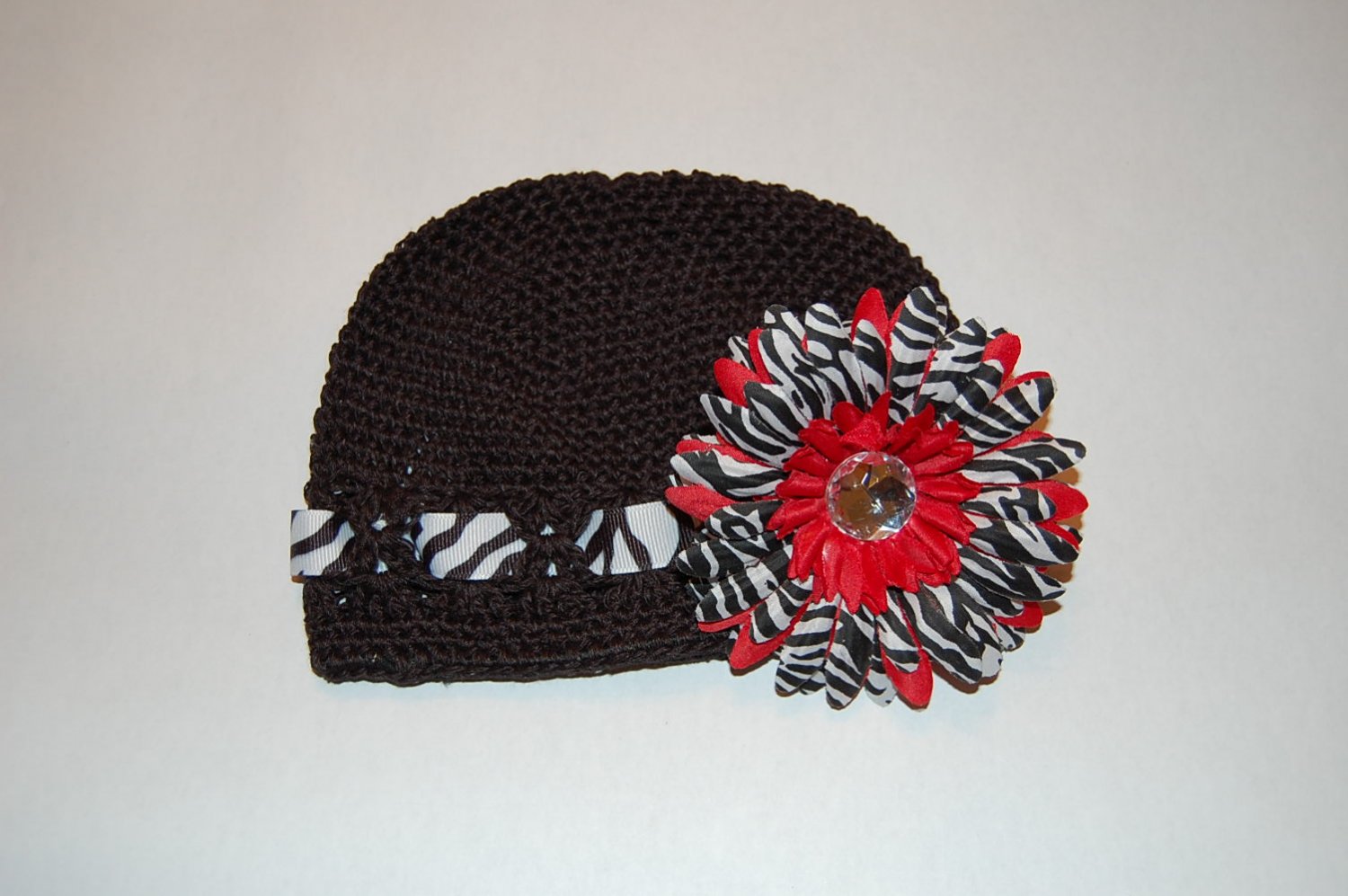 Crocheted Kufi Hat,Black, Zebra Ribbon Accent, Red Zebra Daisy . Sizes NB, SM, MED, LGE