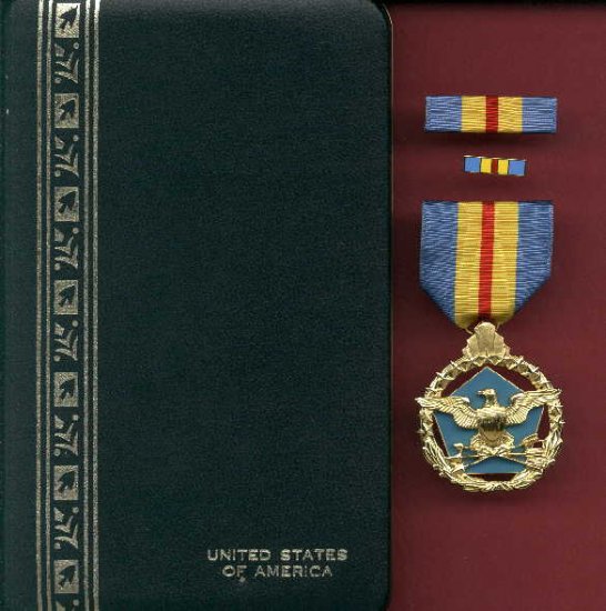 US Defense Distinguished Service medal in case with ribbon bar and lapel pin