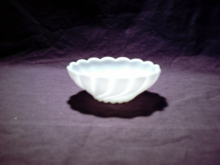 Medium sized white glass bowl swirled design (milk glass?)