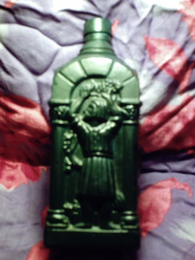 Green Bacchian Bacchus Romanesque bottle depicting wine harvest