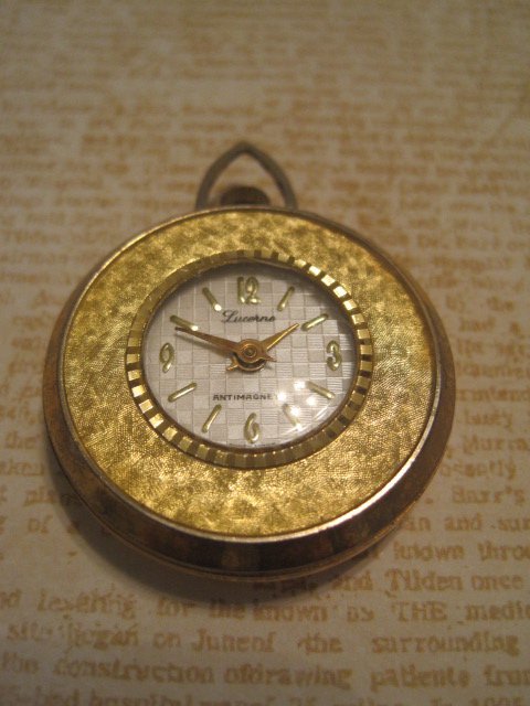 Gold Colored Watch Charm with Flower Pattern on Back