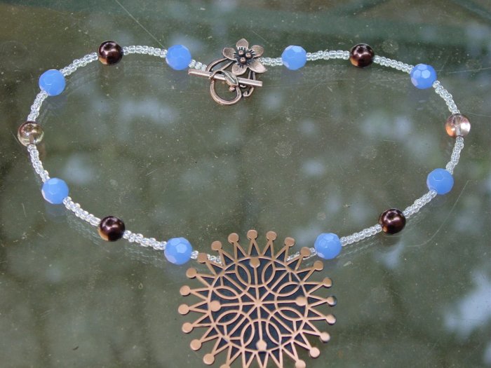 Single strand necklace with vintage copper pendant