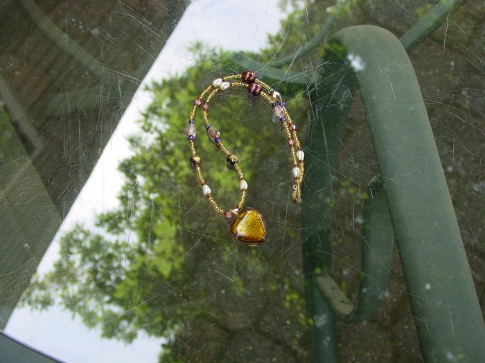 Beautiful gold colored heart necklace.