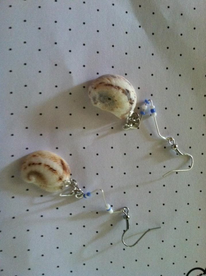 Silver shell earrings with white and light blue beads.