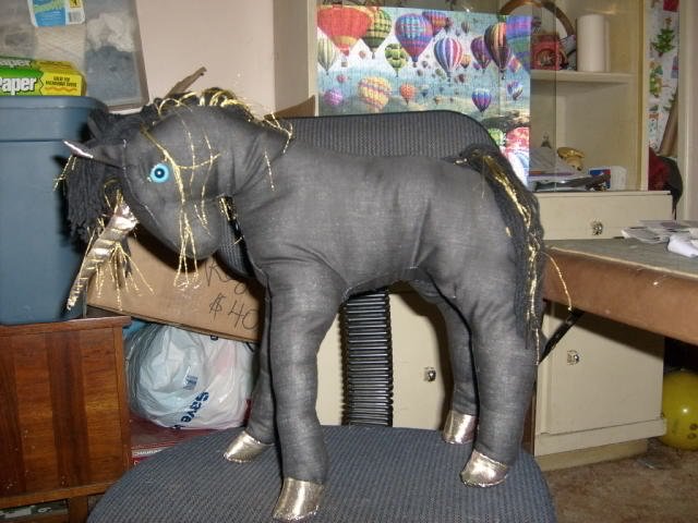 handcrafted stuffed black and gold unicorn