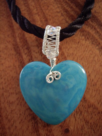 Tagua nut heart with hand woven sterling pendant on cord