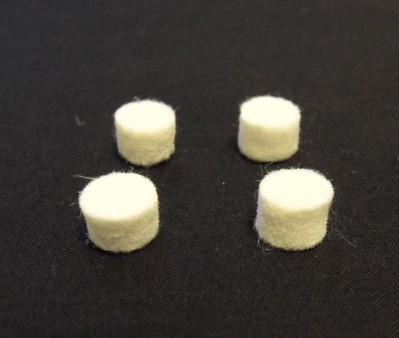 Four 3/8" diameter x 1/4" thick white Saxophone Bumper Felts with expert advice