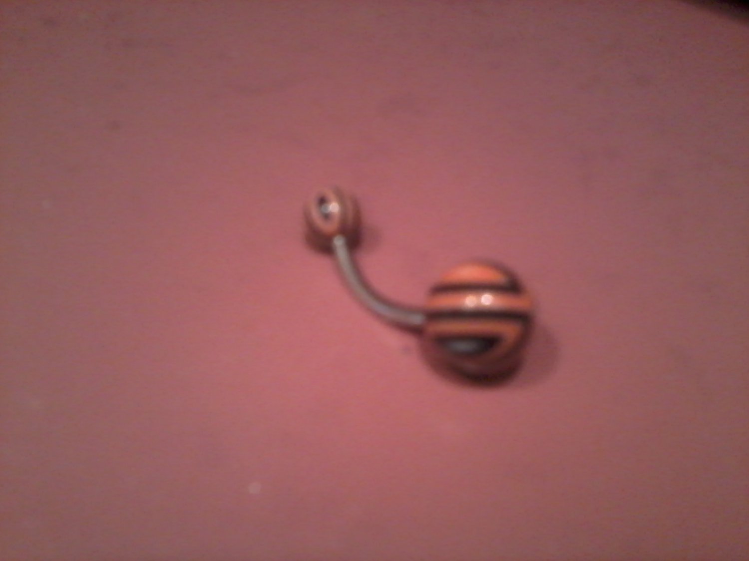 orange black and white belly button ring