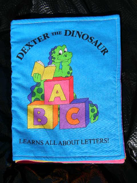 $20.50 Cloth Book 7X10-"Dexter The Dinosaur Learns All About Letters" 10 Pages-Machine Washable