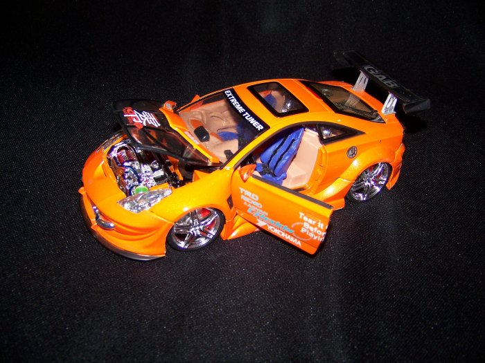 Orange Extreme Tuner Toyota Celica car with moveable doors and working lights