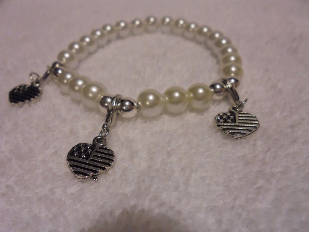 "3 HEART USA" CHARMS ON A WHITE EXPANDABLE BEADED BRACELET....